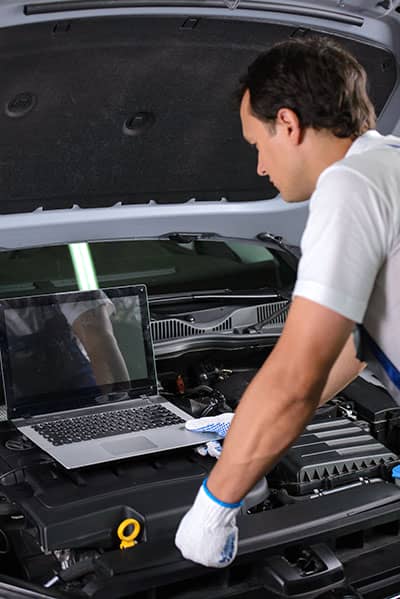 Mobile mechanic checking car before client purchase
